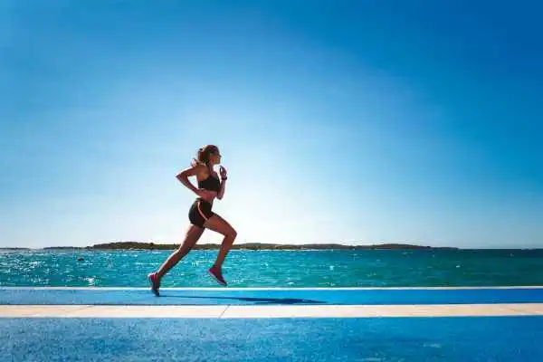 Woman running showing strong leg muscle Leamington Spa